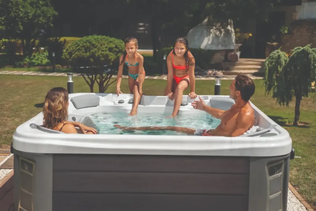 Picture of a family in their hot tub after learning the average hot tub price.